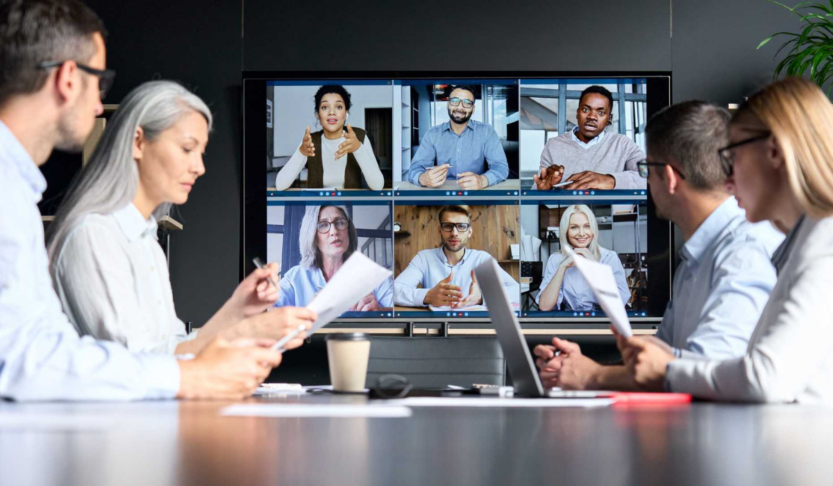 Global business leaders discussing strategy and innovation in a modern corporate office environment.